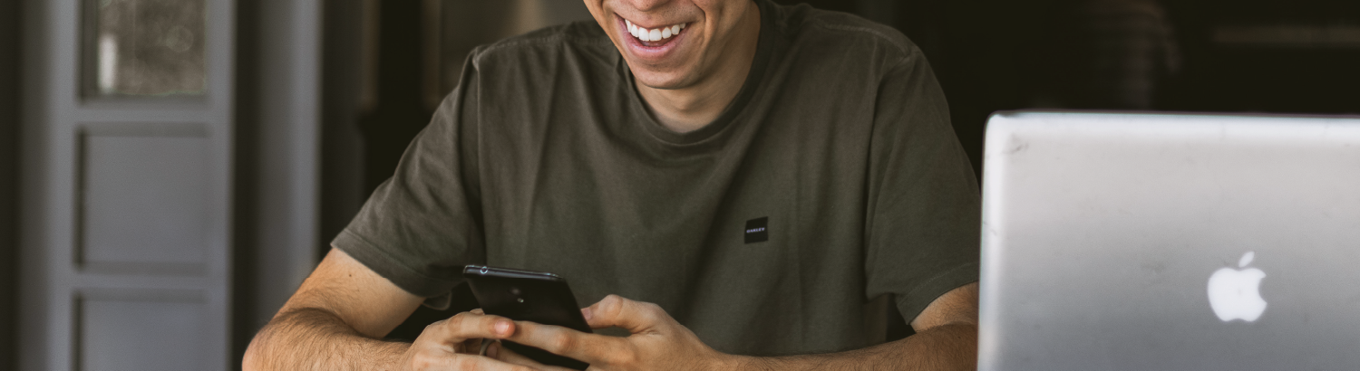 Boy typing on mobile phone.